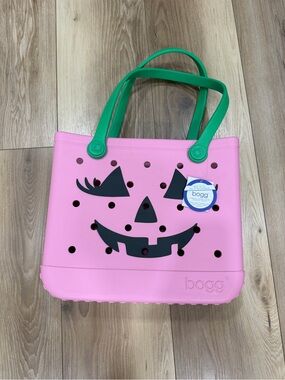 Bogg bag pink jack-o'-lantern tote with green handles -